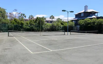 a tennis court with two tennis rackets on it at High Pointe Unit 1-413 by Oversee 30A in Seacrest