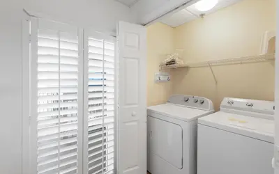 a white laundry room with a washer and dryer at High Pointe Unit 1-413 by Oversee 30A in Seacrest