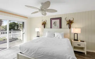 a white bedroom with a bed and a ceiling fan at Holzworth House by Oversee 30A in Santa Rosa Beach