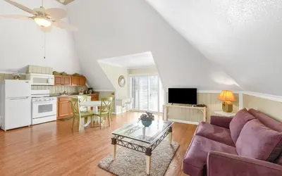 a living room with a couch and a table at Holzworth House by Oversee 30A in Santa Rosa Beach