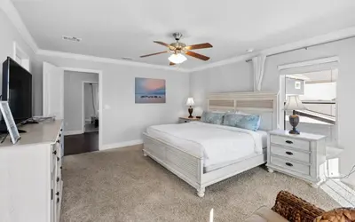 a bedroom with a bed and a ceiling fan at Inlet Beach Cottage by Oversee 30A in Inlet Beach
