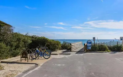 two bikes parked in a parking lot next to the ocean at Inlet Beach Cottage by Oversee 30A in Inlet Beach
