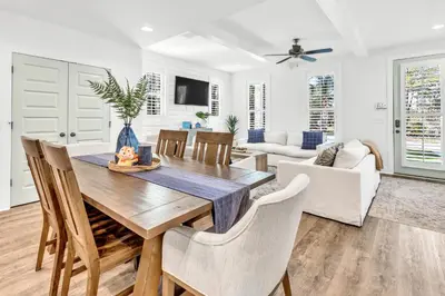 a dining room and living room with a table and chairs at Inlet Beach Paradise by Oversee 30A in Inlet Beach