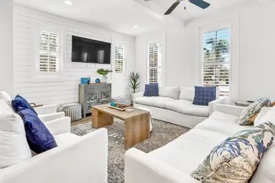 a living room with white furniture and a flat screen tv at Inlet Beach Paradise by Oversee 30A in Inlet Beach