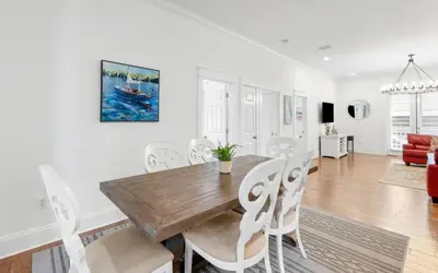 a dining room and living room with a wooden table and chairs at Instant Gratification by Oversee 30A in Santa Rosa Beach