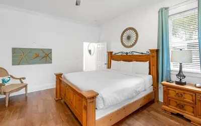 a bedroom with a bed and a chair and a window at Instant Gratification by Oversee 30A in Santa Rosa Beach