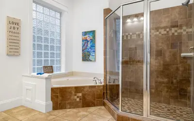 a bathroom with a shower and a tub and a sink at Instant Gratification by Oversee 30A in Santa Rosa Beach