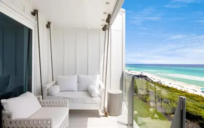 a balcony with a couch and a view of the beach at Into the Mystic by Oversee 30A in Seacrest