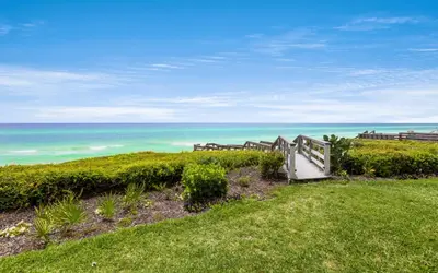 a stairway to the beach with the ocean in the background at Into the Mystic by Oversee 30A in Seacrest