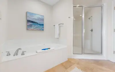 a white bathroom with a tub and a shower at Legacy 201 Emerald Beach by Oversee 30A in Santa Rosa Beach