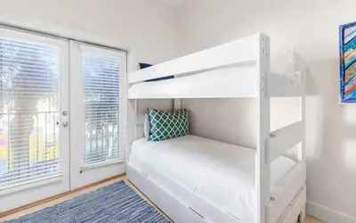 a bedroom with a bunk bed and a window at Legacy 201 Emerald Beach by Oversee 30A in Santa Rosa Beach