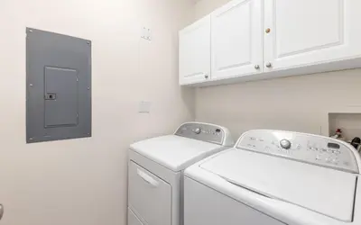 a white laundry room with a washer and dryer at Legacy 201 Emerald Beach by Oversee 30A in Santa Rosa Beach