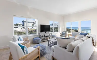 a living room with white furniture and a flat screen tv at Legacy 201 Emerald Beach by Oversee 30A in Santa Rosa Beach