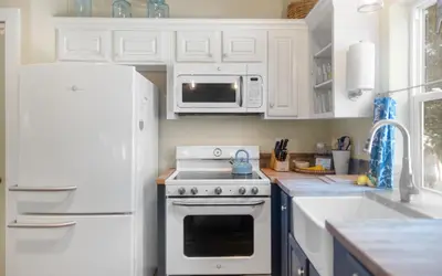a white kitchen with a stove and a microwave at Lemon Squeezy by Oversee 30A in Inlet Beach