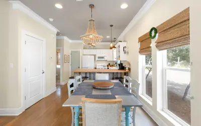 a dining room with a table and chairs at Lemon Squeezy by Oversee 30A in Inlet Beach