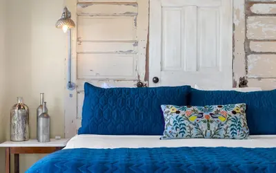 a blue bed with a blue headboard and a pillow at Lemon Squeezy by Oversee 30A in Inlet Beach