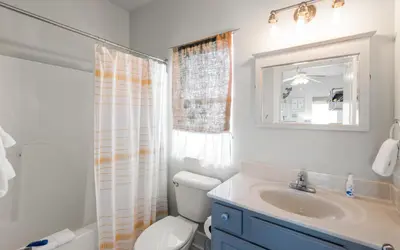 a bathroom with a sink and a toilet and a mirror at Lemon Squeezy by Oversee 30A in Inlet Beach