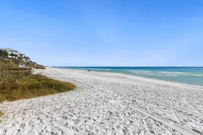 a white sandy beach with the ocean in the background at Lemon Squeezy by Oversee 30A in Inlet Beach