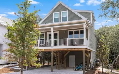 a house with a wrap around porch with a deck at Lofty Oasis by Oversee 30A in Santa Rosa Beach