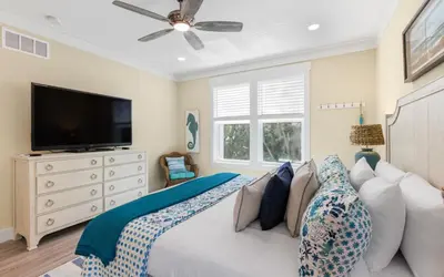 a bedroom with a couch and a flat screen tv at Lofty Oasis by Oversee 30A in Santa Rosa Beach