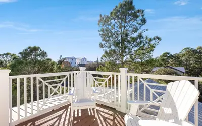 two white chairs sitting on a white deck at Mellow Yellow by Oversee 30A in Santa Rosa Beach