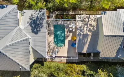 an aerial view of a house with a swimming pool at Mellow Yellow by Oversee 30A in Santa Rosa Beach