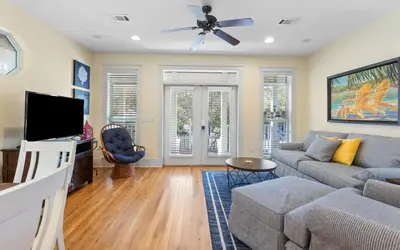 a living room with a couch and a tv at Mellow Yellow by Oversee 30A in Santa Rosa Beach