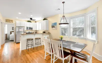 a kitchen and dining room with a table and chairs at Mellow Yellow by Oversee 30A in Santa Rosa Beach
