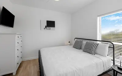 a white bedroom with a bed and a window at Mystic Cottage by Oversee 30A in Inlet Beach