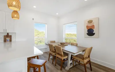 a dining room with a table and chairs at Mystic Cottage by Oversee 30A in Inlet Beach