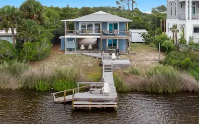 a house on the water with a dock at Noras Place by Oversee 30A in Santa Rosa Beach