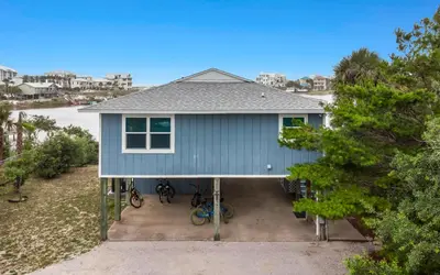 a blue house with bikes parked in front of it at Noras Place by Oversee 30A in Santa Rosa Beach