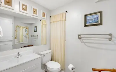 a white bathroom with a toilet and a sink at Noras Place by Oversee 30A in Santa Rosa Beach