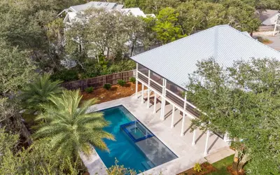 an overhead view of a house with a swimming pool at Palms on Pelican by Oversee 30A in Seacrest