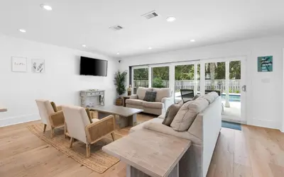 a living room with a couch and a table at Palms on Pelican by Oversee 30A in Seacrest