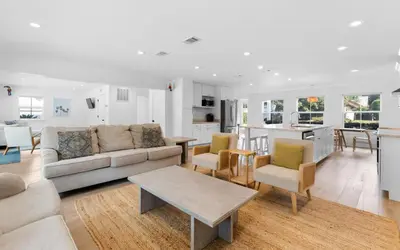 a living room with a couch and a table at Palms on Pelican by Oversee 30A in Seacrest