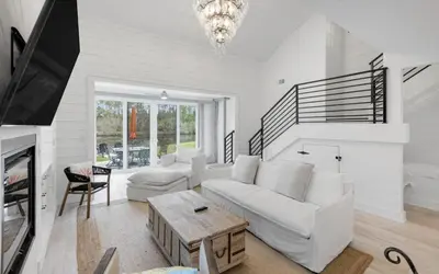a living room with a white couch and a table at Peace of Mind by Oversee 30A in Santa Rosa Beach