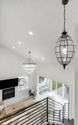 a living room with a fireplace and a chandelier at Peace of Mind by Oversee 30A in Santa Rosa Beach
