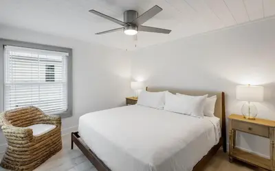 a white bedroom with a bed and a ceiling fan at Peace of Mind by Oversee 30A in Santa Rosa Beach