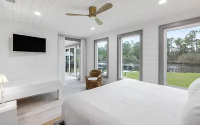 a white bedroom with a bed and a ceiling fan at Peace of Mind by Oversee 30A in Santa Rosa Beach