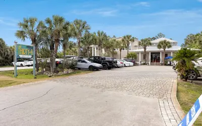 a parking lot with cars parked in front of a building at Peace of Mind by Oversee 30A in Santa Rosa Beach