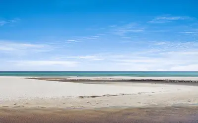 a sandy beach with the ocean in the background at Santa Rosa Seaclusion by Oversee 30A in Santa Rosa Beach