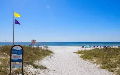 a beach with a sign in the sand and the ocean at Santa Rosa Seaclusion by Oversee 30A in Santa Rosa Beach