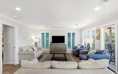 a living room with two couches and a tv at Santa Rosa Seaclusion by Oversee 30A in Santa Rosa Beach
