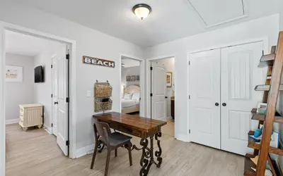 a dining room with a table and a bedroom at Sea Bliss Cottage by Oversee 30A in Inlet Beach