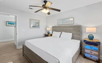 a bedroom with a bed and a ceiling fan at Sea Bliss Cottage by Oversee 30A in Inlet Beach