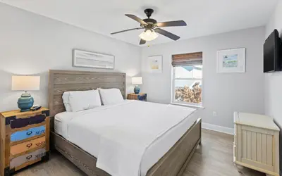 a bedroom with a bed and a ceiling fan at Sea Bliss Cottage by Oversee 30A in Inlet Beach