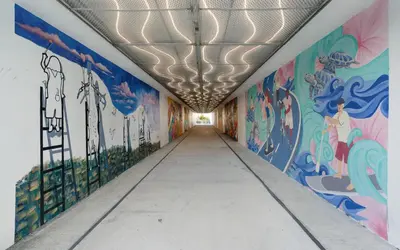 a hallway with colorful murals on the walls at Sea Bliss Cottage by Oversee 30A in Inlet Beach