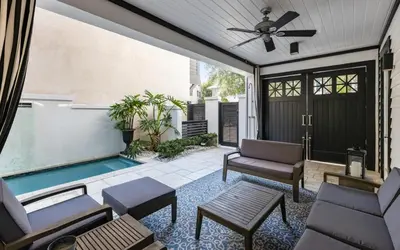 a patio with a pool and a ceiling fan at Serenity by Oversee 30A in Rosemary Beach