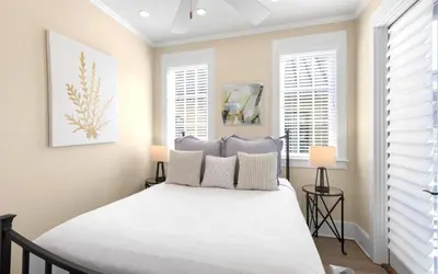 a bedroom with a bed and two windows at Serenity by Oversee 30A in Rosemary Beach